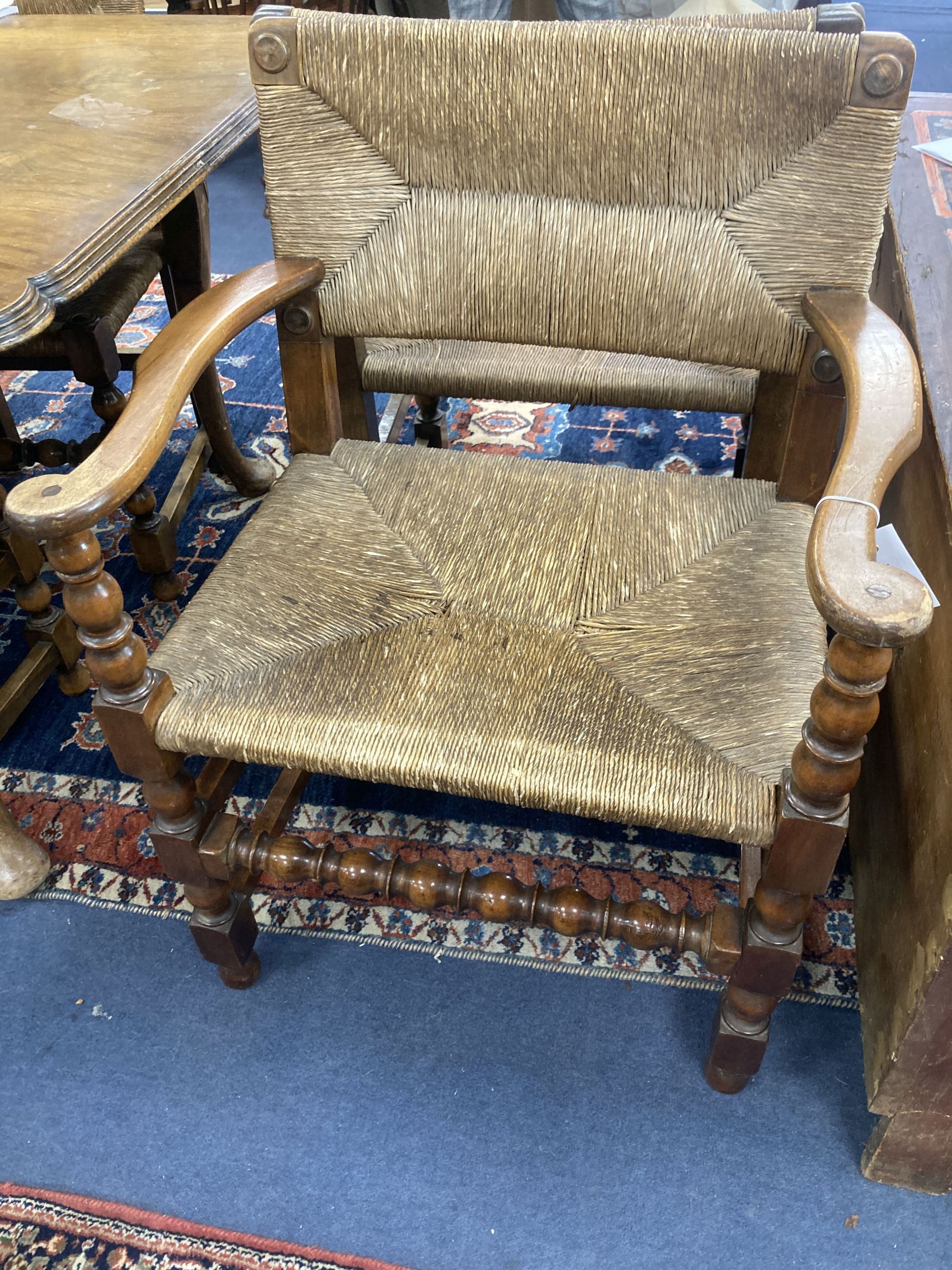 A set of eight turned beech dining chairs with rush seats and backs (two with arms)